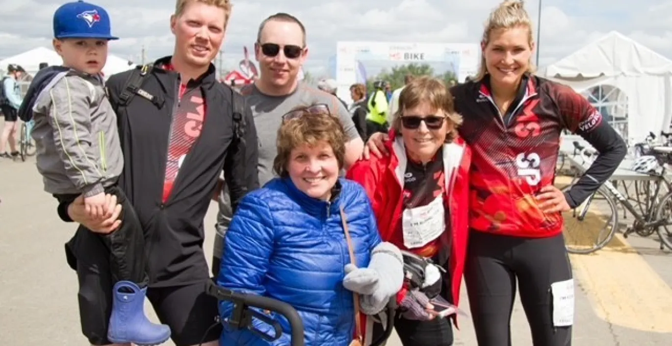 Alli and her family posing outdoors at MS Bike wearing MS Bike jerseys.